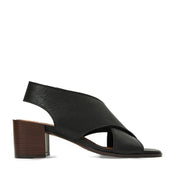 Black sandal with a brown block heel on a white background