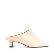 Cream leather mule sandal with peep-toe, and kitten heel. 