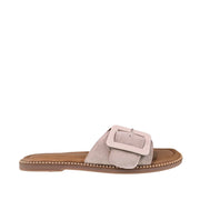 Taupe suede slip-on sandal with oversized buckle detail on a white background.