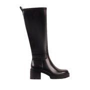 black knee-high heeled boot, lug sole, and zipper side closure on a white background