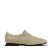 beige ballet flats on a white background