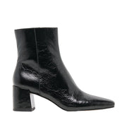 black heeled patent leather ankle boot on a white background