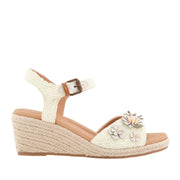 Off-white raffia espadrille wedge sandal with ankle strap buckle, and 3D flower embellishments on toe strap. 