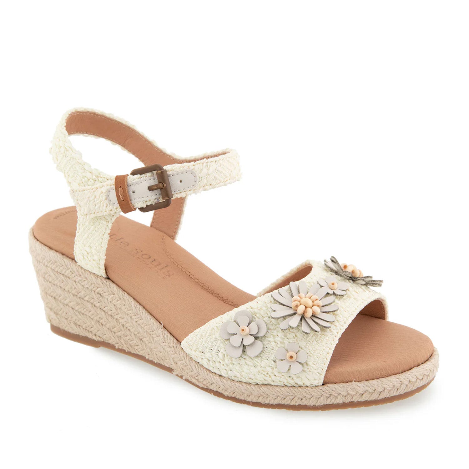 Off-white raffia espadrille wedge sandal with ankle strap buckle, and 3D flower embellishments on toe strap. 