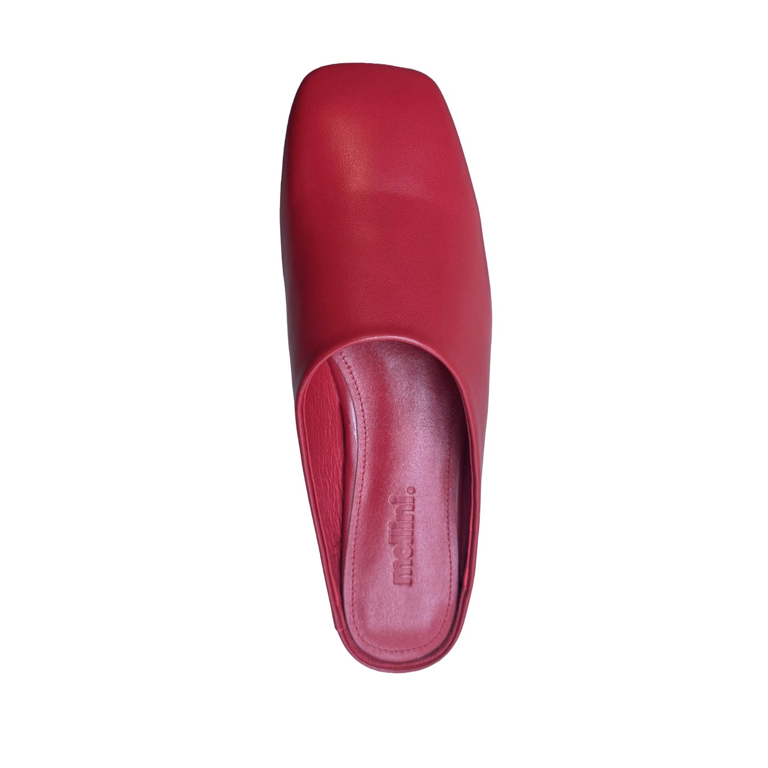 Red slip-on mule shoe on a white background.