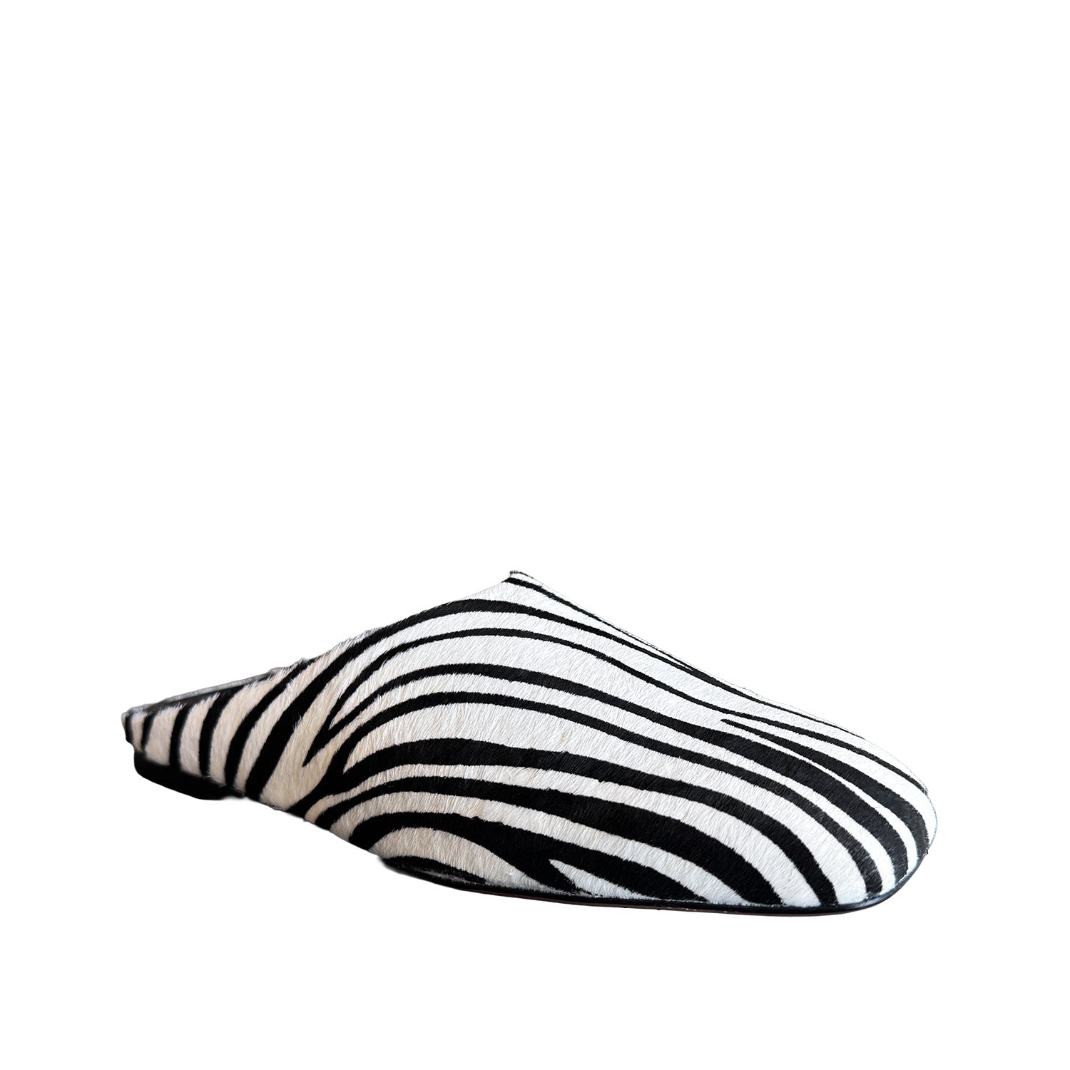 Black and white patterned slip on shoe on a white background