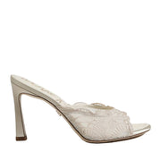 Off-White slip-on high-heeled mule with lace detailing on a white background.