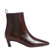 brown leather kitten heel chelsea ankle boot on a black background