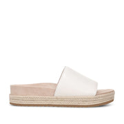 White slip-on slide espadrille sandal on a white background.