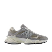 Gray and white sneaker with New Balance logo on a white background